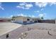 Charming single story home featuring an expansive driveway with low maintenance desert landscaping at 7001 E Flossmoor Ave, Mesa, AZ 85208