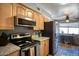 A well-equipped kitchen with stainless steel appliances, granite countertops, and a ceiling fan at 7001 E Flossmoor Ave, Mesa, AZ 85208