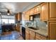 Charming kitchen featuring granite countertops, stainless steel sink, and light wood cabinetry at 7001 E Flossmoor Ave, Mesa, AZ 85208