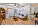 Living area showcasing wood floors, a comfortable sofa, and a view into other rooms at 7001 E Flossmoor Ave, Mesa, AZ 85208