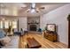 Inviting living room with a brick fireplace, ceiling fan, and wood-look flooring at 7001 E Flossmoor Ave, Mesa, AZ 85208