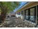 Inviting patio with beautiful stone pavers, outdoor swing, and lots of shade at 7001 E Flossmoor Ave, Mesa, AZ 85208
