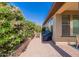 Attractive backyard patio featuring brick pavers, lush plants, and seating, ideal for outdoor living at 720 E Cobble Stone Dr, Queen Creek, AZ 85140