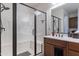 Bathroom boasting an enclosed shower with dark trim, tiled floor, and a gray bath mat at 720 E Cobble Stone Dr, Queen Creek, AZ 85140