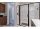 Bathroom featuring an enclosed shower with dark trim and a dark wood vanity at 720 E Cobble Stone Dr, Queen Creek, AZ 85140