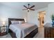 Bedroom featuring a dark wooden bed frame, neutral bedding, bedside table, and dark wood dresser at 720 E Cobble Stone Dr, Queen Creek, AZ 85140