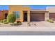 Charming single-story home featuring a well-maintained front yard and a two-car garage at 720 E Cobble Stone Dr, Queen Creek, AZ 85140