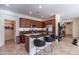 Modern kitchen featuring a large island with seating, wood cabinets, and stainless steel appliances at 720 E Cobble Stone Dr, Queen Creek, AZ 85140