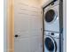 Conveniently located laundry room featuring a stacked washer and dryer for efficient space-saving at 720 E Cobble Stone Dr, Queen Creek, AZ 85140