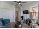 Bright living space featuring a ceiling fan, carpet, and a large flatscreen tv at 720 E Cobble Stone Dr, Queen Creek, AZ 85140