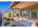 Cozy covered patio with outdoor seating and landscaping offers a relaxing retreat at 720 E Cobble Stone Dr, Queen Creek, AZ 85140