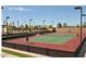 Well-maintained tennis court with vibrant green and red surfaces, ready for a match at 720 E Cobble Stone Dr, Queen Creek, AZ 85140