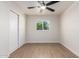Light and bright bedroom with light wood floors, a window, and ceiling fan at 7647 E Montecito Ave, Scottsdale, AZ 85251