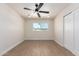 Bright bedroom features wood floors, a ceiling fan, and a sun-filled window at 7647 E Montecito Ave, Scottsdale, AZ 85251