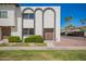 Charming townhouse featuring unique arched brickwork and a well-maintained front lawn at 7647 E Montecito Ave, Scottsdale, AZ 85251