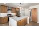 Beautiful updated kitchen featuring modern stainless steel appliances and stylish island at 7647 E Montecito Ave, Scottsdale, AZ 85251