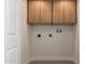 Laundry room featuring wood cabinets and washer/dryer hookups at 7647 E Montecito Ave, Scottsdale, AZ 85251
