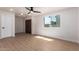 Cozy living room with wood flooring, a ceiling fan, and a large window providing natural light at 7647 E Montecito Ave, Scottsdale, AZ 85251