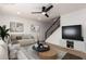 Cozy living room with modern decor, a plush sofa, and a stylish round coffee table at 7647 E Montecito Ave, Scottsdale, AZ 85251