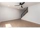 Bright, spacious living room features wood flooring, a fan and staircase at 7647 E Montecito Ave, Scottsdale, AZ 85251