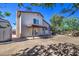 Expansive backyard showcasing the home's exterior, a patio, and ample space for landscaping at 7844 W Jenan Dr, Peoria, AZ 85345
