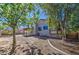 Beautiful home exterior view with an expansive backyard, inviting patio, and lush trees at 7844 W Jenan Dr, Peoria, AZ 85345