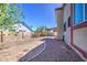 Spacious backyard featuring a graveled landscape, complemented by a sturdy fence for privacy and security at 7844 W Jenan Dr, Peoria, AZ 85345