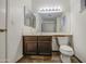 Well-lit bathroom featuring a vanity with ample storage and a large mirror over the sink at 7844 W Jenan Dr, Peoria, AZ 85345