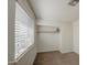 Bedroom featuring neutral walls, carpet flooring, a large window, and closet at 7844 W Jenan Dr, Peoria, AZ 85345