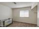 Cozy bedroom with neutral walls, carpet flooring, and a large window for natural light at 7844 W Jenan Dr, Peoria, AZ 85345