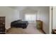 Spacious bedroom with neutral carpet and ample natural light at 7844 W Jenan Dr, Peoria, AZ 85345