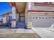 Inviting home showcasing a two-car garage, stone accents, and a well-kept front yard at 7844 W Jenan Dr, Peoria, AZ 85345
