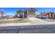 Inviting two-story home showcasing desert landscaping, a 2-car garage, and a vibrant red bush at 7844 W Jenan Dr, Peoria, AZ 85345