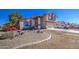 This home features red brick accents, a two-car garage, and desert landscaping at 7844 W Jenan Dr, Peoria, AZ 85345