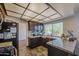 Traditional kitchen featuring granite countertops, dark wood cabinets, and a large window at 7844 W Jenan Dr, Peoria, AZ 85345