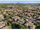 Expansive aerial view of a well-maintained neighborhood featuring diverse homes and lush landscaping against a mountain backdrop at 834 W Whitten St, Chandler, AZ 85225