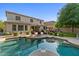 Inviting backyard with a sparkling pool, patio seating, lush landscaping, and a cozy firepit at 834 W Whitten St, Chandler, AZ 85225