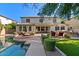 Backyard features a swimming pool, artificial turf, outdoor kitchen and living area at 834 W Whitten St, Chandler, AZ 85225