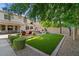 A backyard including synthetic grass, outdoor kitchen and fireplace at 834 W Whitten St, Chandler, AZ 85225