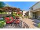 Inviting backyard with lush landscaping, comfortable seating, and a brick patio at 834 W Whitten St, Chandler, AZ 85225
