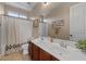 Well-lit bathroom featuring double sinks, a shower with a curtain, and neutral decor at 834 W Whitten St, Chandler, AZ 85225