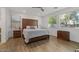 Bright bedroom featuring wood floors, a wooden headboard, and natural light from the windows at 834 W Whitten St, Chandler, AZ 85225