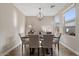 Bright dining room featuring a modern chandelier, six chairs, and a decorative console at 834 W Whitten St, Chandler, AZ 85225