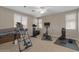 Spacious exercise room with multiple workout machines, bright windows, and neutral carpet at 834 W Whitten St, Chandler, AZ 85225