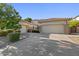 Spacious home featuring a three-car garage, desert landscaping and large driveway at 834 W Whitten St, Chandler, AZ 85225