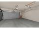 Clean garage with light gray epoxy flooring and a neutral-colored garage door at 834 W Whitten St, Chandler, AZ 85225