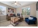 Bright home office featuring a wooden desk, ceiling fan, and window with blinds at 834 W Whitten St, Chandler, AZ 85225