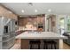Well-lit kitchen featuring stainless steel appliances, a center island with bar seating, and wooden cabinets at 834 W Whitten St, Chandler, AZ 85225
