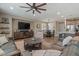 Comfortable living room with a ceiling fan, open layout, and adjacent dining and kitchen areas at 834 W Whitten St, Chandler, AZ 85225