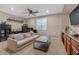 Inviting living room featuring a ceiling fan, comfortable seating, and modern decor elements at 834 W Whitten St, Chandler, AZ 85225